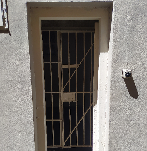 Old wrap around cell lock on door frame